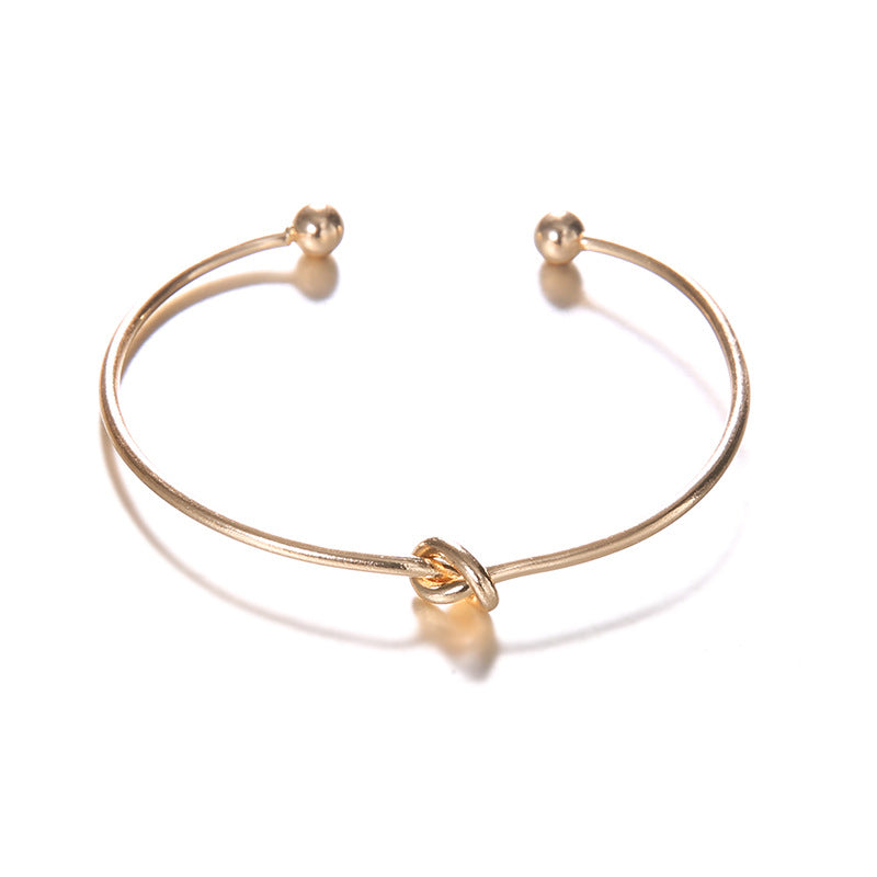 Pulseira aberta com nó de flecha